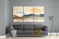 Three-panel abstract wall art above a gray sofa in a living room.