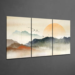 Triptych wall art of a sunset over mountains with birds on a gray wall.