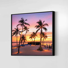 Framed artwork of a tropical sunset with palm trees on a beach.